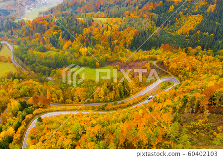 Picturesque autumn landscape with road between the hills. Czech Republic 60402103