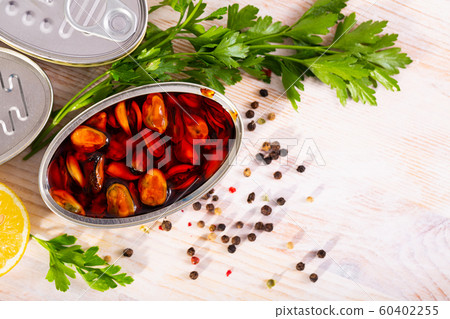 Marinated mussels in oil with herbs and lemon Marinated mussels in oil with herbs and lemon 60402255