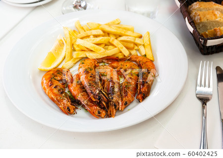 Grilled shrimps with french fries Grilled shrimps with french fries 60402425