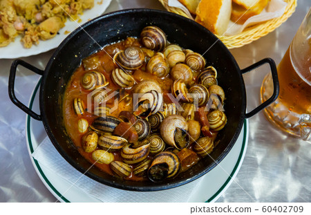 Spanish tapa Caracoles en salsa 60402709
