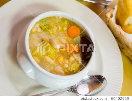 Bean's catalan soup with carrots and potatoes, served with black sausage Bean's catalan soup with carrots and potatoes, served with black sausage 60402969