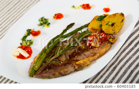 Roasted veal steak with baked vegetables, adjika and garlic sauce Roasted veal steak with baked vegetables, adjika and garlic sauce 60403185