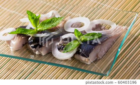 Salted herring with onion on bamboo background Salted herring with onion on bamboo background 60403196