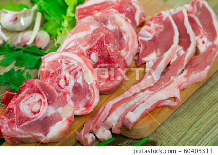 Raw lamb meat with vegetables 60403311