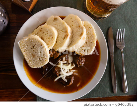 Czech dumplings with beef goulash Czech dumplings with beef goulash 60403392