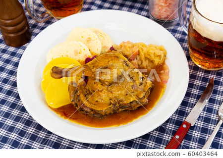 Roasted quarter duck with red and white cabbage, bread and potato dumplings 60403464