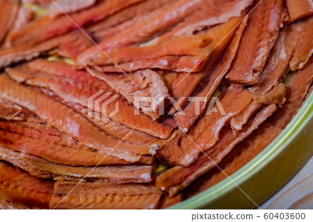 Closeup of salted anchovy fillets in oil Closeup of salted anchovy fillets in oil 60403600