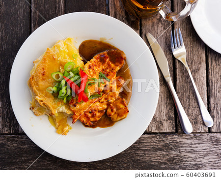 Chicken fillet served with baked potato Chicken fillet served with baked potato 60403691