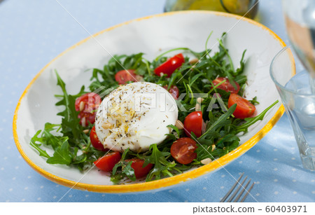 Salad with burrata italian cheese, cherry tomatoes and arugula green leaf Salad with burrata italian cheese, cherry tomatoes and arugula green leaf 60403971