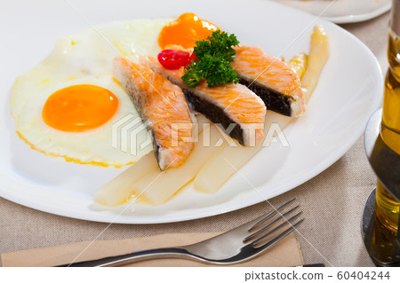 Fried eggs with salmon and asparagus Fried eggs with salmon and asparagus 60404244