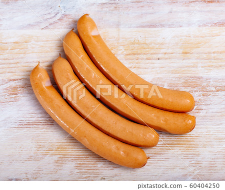 Tasty czech chicken sausages on wooden table Tasty czech chicken sausages on wooden table 60404250