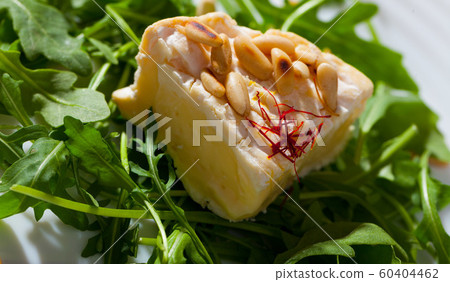 Camembert cheese with pine nuts and arugula Camembert cheese with pine nuts and arugula 60404462