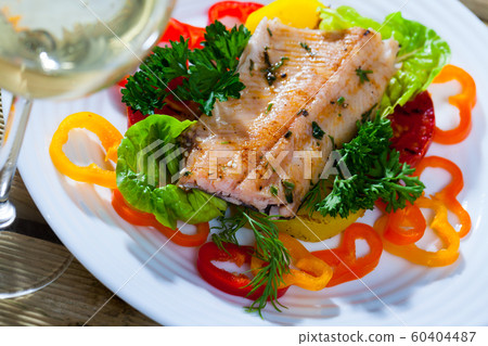 Fried trout fillets with vegetables and white wine Fried trout fillets with vegetables and white wine 60404487