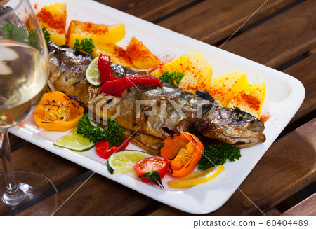 Baked trout with vegetables Baked trout with vegetables 60404489
