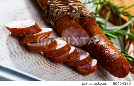 Roasted chezh sausages on cutting board Roasted chezh sausages on cutting board 60404520