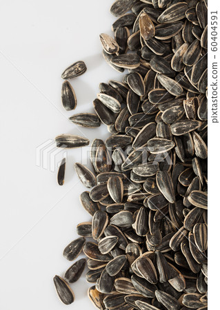 Sunflower seeds on a white surface Sunflower seeds on a white surface 60404591