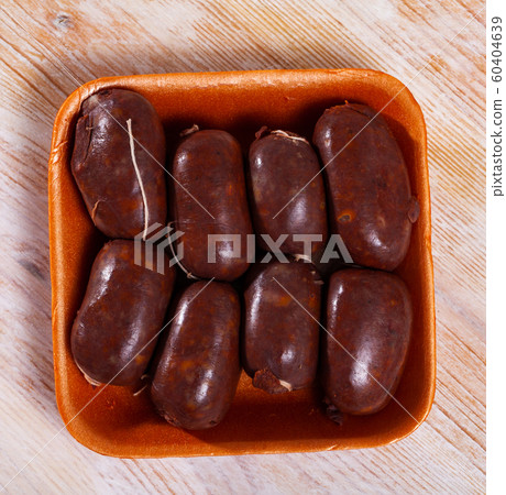 Blood sausages on wooden table 60404639