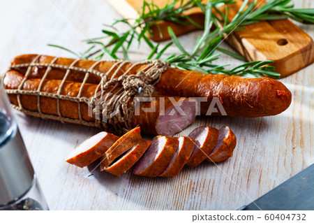 Roasted chezh sausages on cutting board Roasted chezh sausages on cutting board 60404732