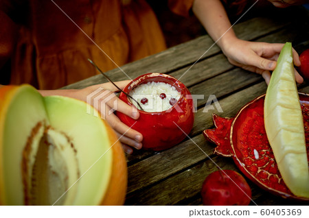 Red ceramic, handmade.Shaped like a grenade. Children's hands around the pot of porridge. Wholesome breakfast 60405369