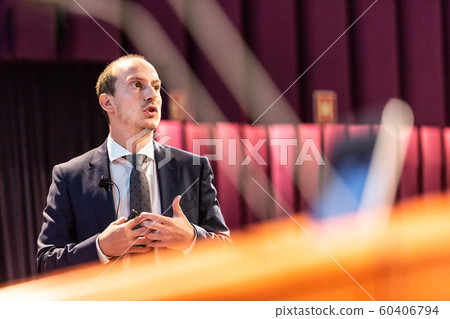 Public speaker giving talk at Business Event. 60406794