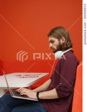 Young man typing on laptop Young man typing on laptop 60408933