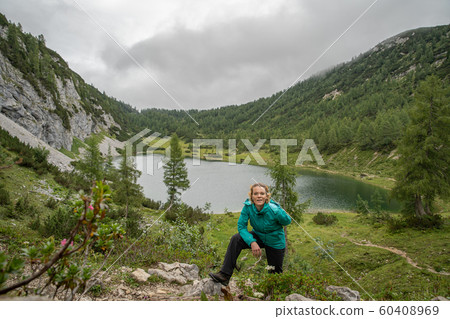 hikers in the austrian alps walk on mountain hiking trails in the woods around the lakes hikers in the austrian alps walk on mountain hiking trails in the woods around the lakes 60408969