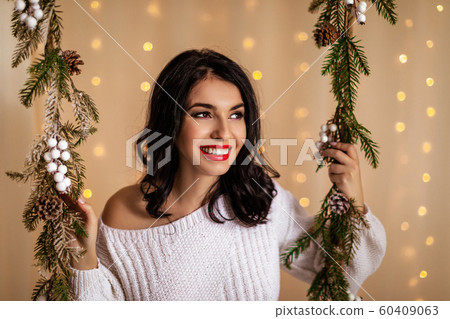 beautiful woman on swing with Christmas decorations 60409063