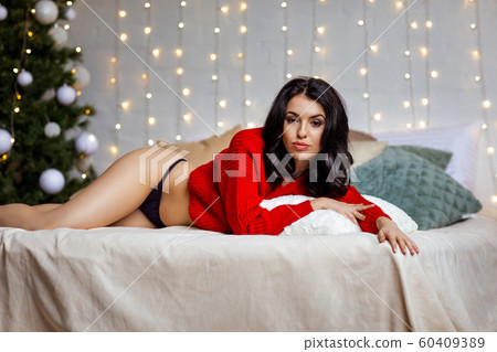 beautiful sexy woman in erotic black lace lingerie and red sweater 60409389