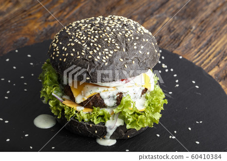 black burger with meat and vegetables black burger with meat and vegetables 60410384