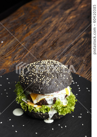 black burger on a slate board black burger on a slate board 60410385