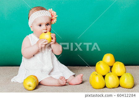 baby girl in a dress with Green apples baby girl in a dress with Green apples 60412284