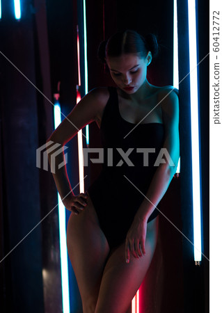 Sensual woman under neon illumination Sensual woman under neon illumination 60412772