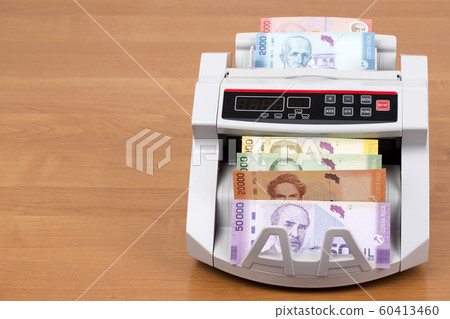 Costa Rican money in a counting machine Costa Rican money in a counting machine 60413460