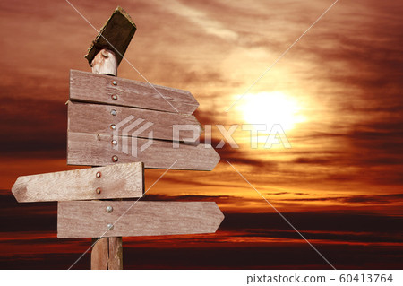 directional wooden arrows in sunset background 60413764