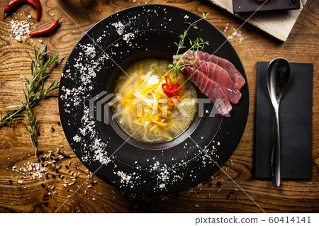 Clear Fish soup served in a bowl in restaurant Clear Fish soup served in a bowl in restaurant 60414141