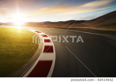 Motion blurred racetrack with mountain background , warm mood 60414692