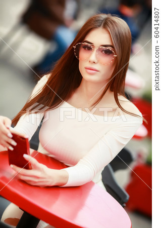 Close-up portrait of pretty young lady with stylish makeup and curly long hair. Big lips, soft skin Close-up portrait of pretty young lady with stylish makeup and curly long hair. Big lips, soft skin 60414807