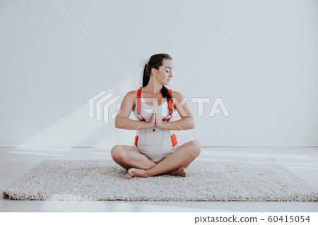 a pregnant woman is engaged in gymnastics and yoga a pregnant woman is engaged in gymnastics and yoga 60415054