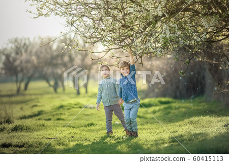 Two friends in the summer in the Park have fun and frolic outdoors Two friends in the summer in the Park have fun and frolic outdoors 60415113