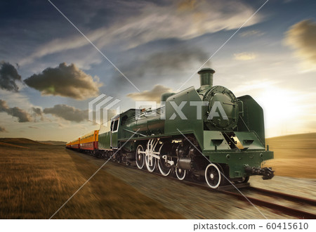 vintage green and yellow steam powered railway train moving vintage green and yellow steam powered railway train moving 60415610