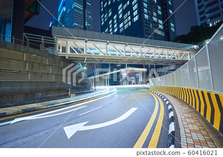 Empty asphalt city street road with walkway bridge and light trail , night scene 60416021