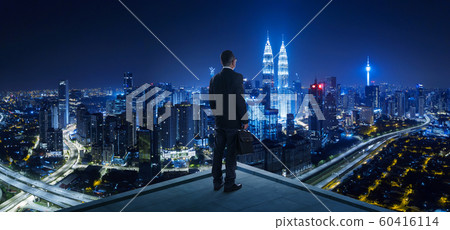 Businessman stand at rooftop looking great cityscape view and thinking business plan of the future . Night scene . Businessman stand at rooftop looking great cityscape view and thinking business plan of the future . Night scene . 60416114