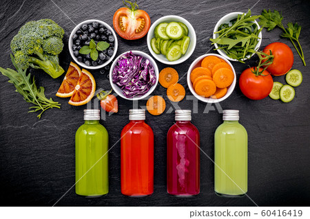 Colourful healthy smoothies and juices in bottles 60416419