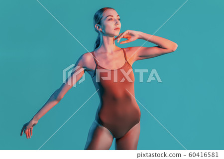 Stunning portrait of female ballerina on neon background in studio. Beautiful mysterious girl with healthy slim body. Concept of art, sports, ballet, dance. Stunning portrait of female ballerina on neon background in studio. Beautiful mysterious girl with healthy slim body. Concept of art, sports, ballet, dance. 60416581