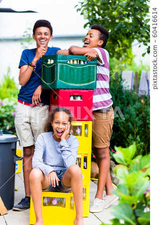 Happy kids near the bottles crate Happy kids near the bottles crate 60416614
