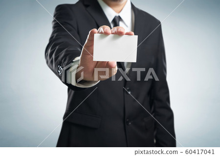 Man's hand showing business card - closeup shot on 60417041