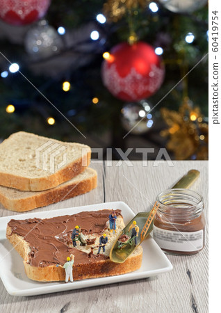 Figurines workers on bread and chocolate cream Figurines workers on bread and chocolate cream 60419754