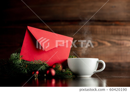 Cup of coffee and red envelope on wooden table Cup of coffee and red envelope on wooden table 60420190
