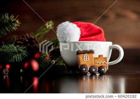 Santa Claus hat and cup with gingerbread cookie Santa Claus hat and cup with gingerbread cookie 60420192