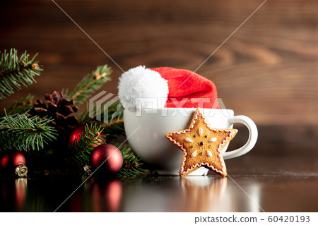 Santa Claus hat and cup with gingerbread cookie Santa Claus hat and cup with gingerbread cookie 60420193